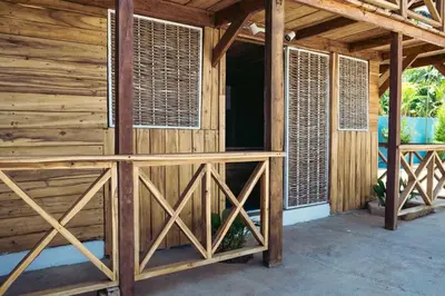 a wooden building with wooden doors and windows at Parador El Ermitaño in Santa Bárbara de Samaná