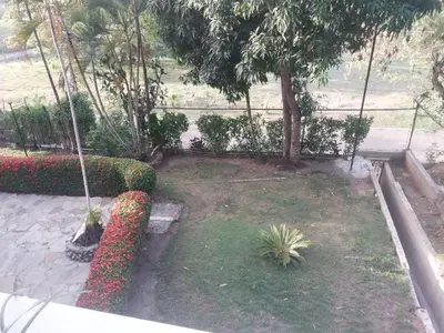 a garden with red and white flowers and trees at Tropical Optimal Tropicana Sur in Sosúa