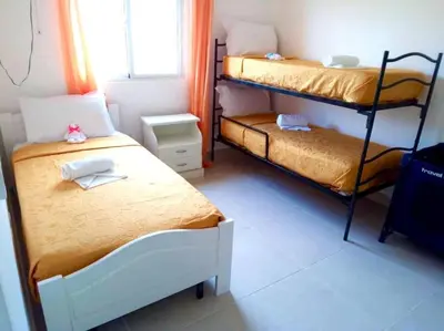a bedroom with two bunk beds and a window at Villa Vintage. in Boca Chica