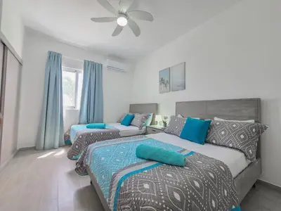 a bedroom with two beds and a ceiling fan at Beauty Apartment Coral Village 2 close to the beach in Punta Cana