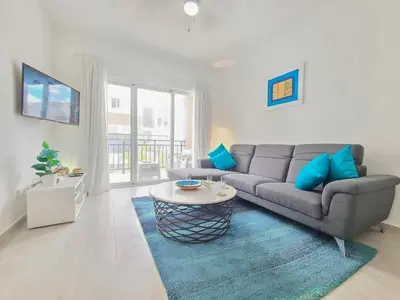 a living room with a couch and a table at Beauty Apartment Coral Village 2 close to the beach in Punta Cana