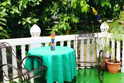 a table with a candle on a fence at Apartamento entero en Samaná Los tios 1 y 2 in Santa Bárbara de Samaná