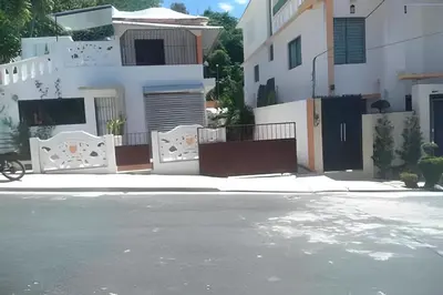 a house with a gate in front of a street at Apartamento entero en Samaná Los tios 1 y 2 in Santa Bárbara de Samaná