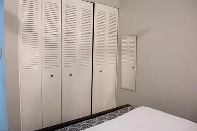 a white bedroom with white closets and a bed at Apartamento entero en Samaná Los tios 1 y 2 in Santa Bárbara de Samaná