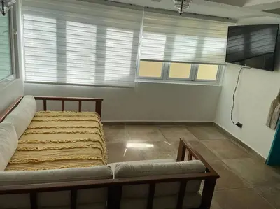 a large bed in a room with a tv at Amazing apartment, B-Juan Dolio, El Bonio II in Juan Dolio