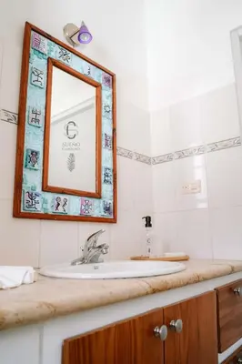 a bathroom with a sink and a mirror on a counter at Sueño Caribeño in La Laguna