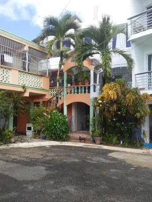 a building with palm trees in front of it at Appart-hotel Veras Samana No-14 in Santa Bárbara de Samaná
