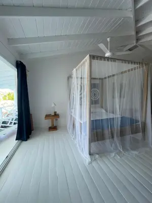 a room with a bed and a window on a boat at ITAKA LOMA BONITA in Las Terrenas
