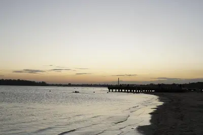 a beach with a pier in the water at Villa Gumio 2BR Apt- 7 min walk to Boca Chica Beach apts in Boca Chica