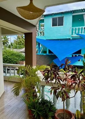 a blue house with plants on a balcony at Casa MIA in Cabarete