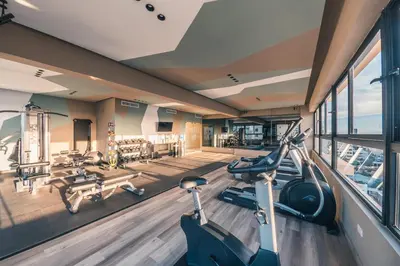 a gym with bikes and treadmills in a building at Breakfast Included at Regatta Living 605 in Los Prados