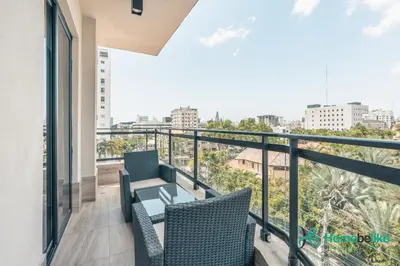 a balcony with two chairs and a table at Regatta Living II with Breakfast Included! - 502 in Los Prados
