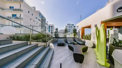 a balcony with couches and chairs on a building at Regatta Living II with Breakfast Included! - 502 in Los Prados