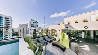 a balcony with a pool and a building at Regatta Living II with Breakfast Included! - 502 in Los Prados