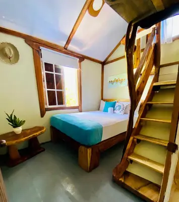 a bedroom with a bunk bed and a staircase at Baby Rustic in Punta Rucia