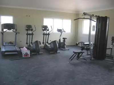 a gym with several tread machines in a room at Laguna Golf in Punta Cana