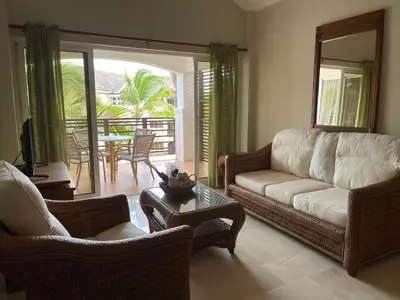 a living room with a couch and chairs and a table at Laguna Golf in Punta Cana