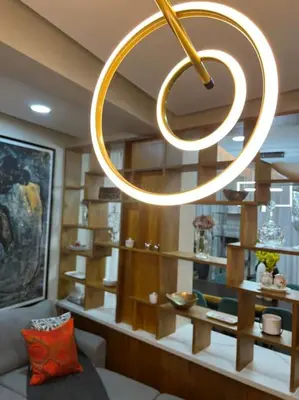 a circular light hanging from the ceiling in a living room at Lux Ph & Rooftop Terrace to Relax in Santiago de los Caballeros