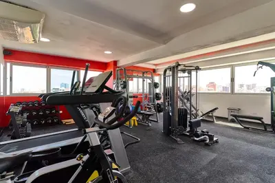 a gym with several tread machines in a room at Central Suites Tower in Santo Domingo