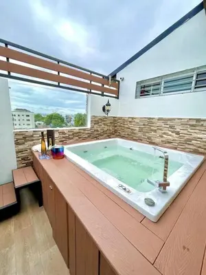 a large bath tub in a room with a large window at Luxury 5 Beds Penthouse - Private Jacuzzi & Karaoke Bar & Free Parking in Santiago de los Caballeros