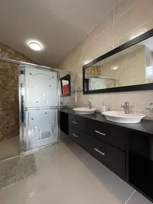 a large bathroom with two sinks and a shower at Luxury 5 Beds Penthouse - Private Jacuzzi & Karaoke Bar & Free Parking in Santiago de los Caballeros