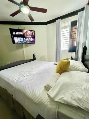 a bedroom with two beds and a ceiling fan at Luxury 5 Beds Penthouse - Private Jacuzzi & Karaoke Bar & Free Parking in Santiago de los Caballeros