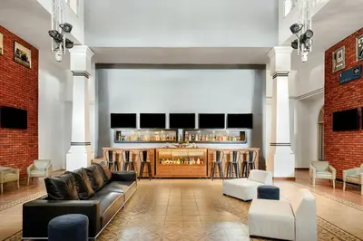 a living room with a couch and a bar at Sunscape Dominicus La Romana - All Inclusive in Bayahibe