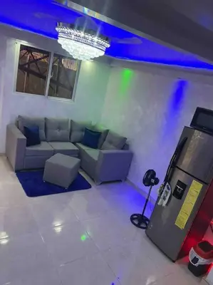 a living room with a couch and a game console at Alojamiento paulino in Santiago de los Caballeros