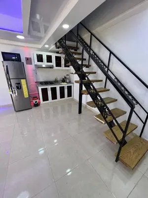 a kitchen with a staircase in the middle of a room at Alojamiento paulino in Santiago de los Caballeros