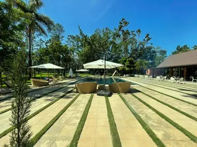 a pool with tables and umbrellas and chairs at Hotel Pinar Dorado By Hotel Gran Jimenoa in Jarabacoa