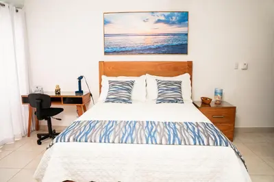 a bedroom with a bed and a desk with a computer at Habitación privada en Puerto Plata Bayardo in San Felipe de Puerto Plata