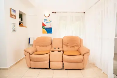 a pair of chairs sitting in a living room at Apartamento Los Anturios en Puerto Plata Bayardo in San Felipe de Puerto Plata