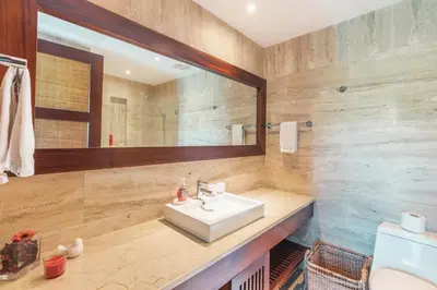 a bathroom with a sink and a mirror at Nearby beach and beach club at Portillo NF in Las Terrenas