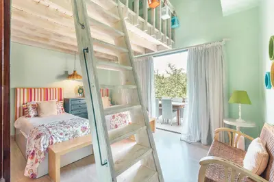 a bedroom with a bunk bed and a ladder at Nearby beach and beach club at Portillo NF in Las Terrenas