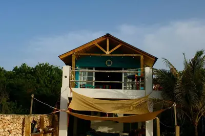 a building with a hammock in front of it at Villas El Bucanero in San Felipe de Puerto Plata