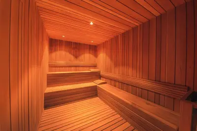 a large wooden sauna with wooden seats in it at Breakfast Included at Regatta Living II 203 in Los Prados