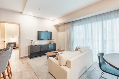 a living room with a white couch and a table at Breakfast Included at Regatta Living II 203 in Los Prados