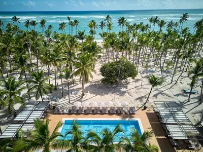 an aerial view of a resort with a pool and the beach at Riu Palace Macao - Adults Only - All Inclusive in Punta Cana