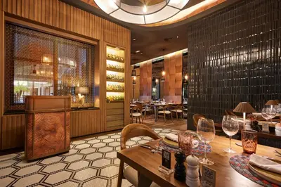 a dining room with a table and wine glasses at Riu Palace Macao - Adults Only - All Inclusive in Punta Cana