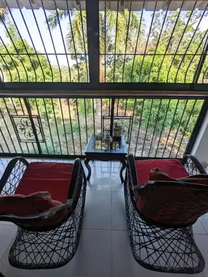 a room with two chairs and a table in front of a window at Apartamento a 5 min de la playa in San Felipe de Puerto Plata