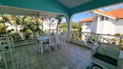 a patio with a table and chairs on a balcony at Villa Preciosa in Bayahibe