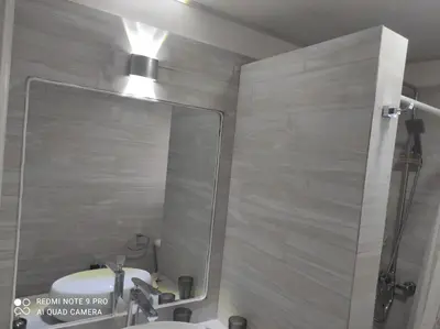 a bathroom with a shower and a sink and a mirror at Villa Preciosa in Bayahibe