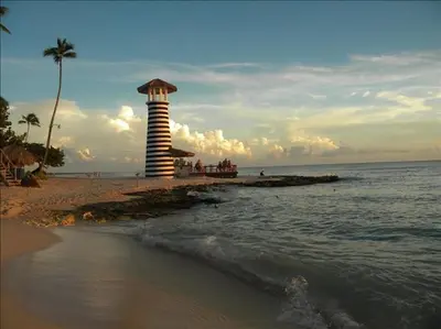 a lighthouse on the shore of a beach at Casa Vacanze Dume in Bayahibe