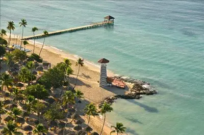 an aerial view of a beach with palm trees and a pier at Casa Vacanze Dume in Bayahibe