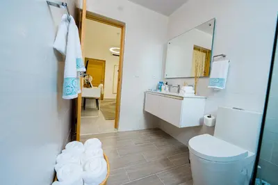 a bathroom with a toilet and a sink and a mirror at Stunning view of the city. in Santo Domingo