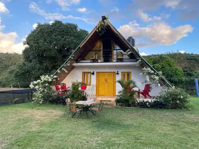 a house with a yellow door and a table and chairs at Dreamvilles Ecovillage Las Galeras in Las Galeras