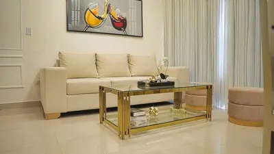 a living room with a couch and a glass table at Premium space in Santiago- 5 Min Away from airport in Santiago de los Caballeros