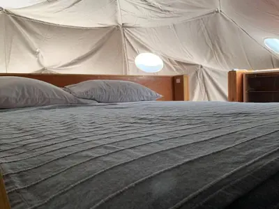 a large bed in a tent with two pillows at Domescape Glamping in El Cedro
