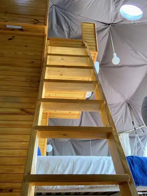 a ladder leading up to a room in a tent at Domescape Glamping in El Cedro