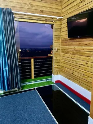 a room with a television and a window with a view at Villa Leon in Jarabacoa
